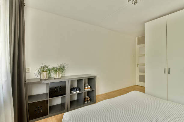 istock Stylish bedroom with bed and wardrobe 1457489744