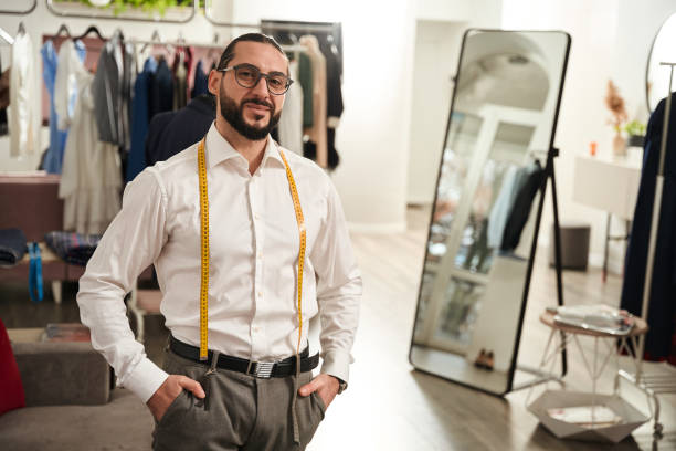 istock Pleased tailor posing for camera in his atelier 1457490870