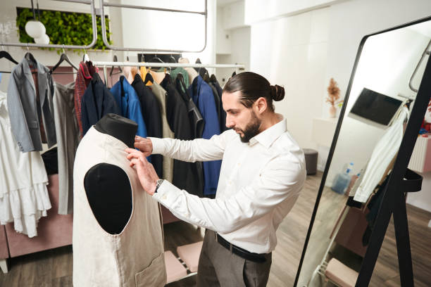 istock Experienced tailor is trying on vest on mannequin 1457491361