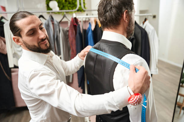 istock Tailor focused on taking customer body measurements 1457491769