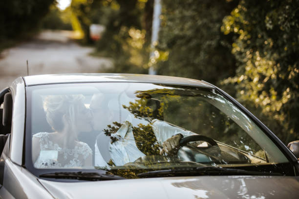 istock Just married young couple in convertible car 1457493718