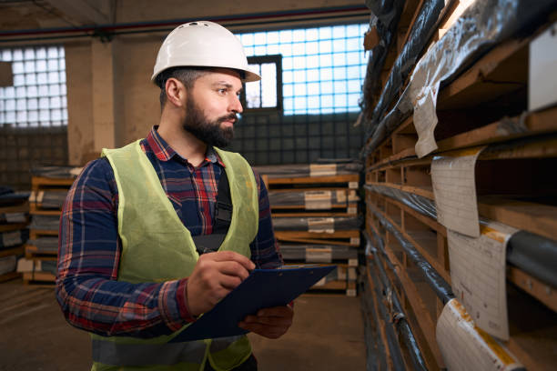 istock Portrait of man making notes in warehouse 1457496130