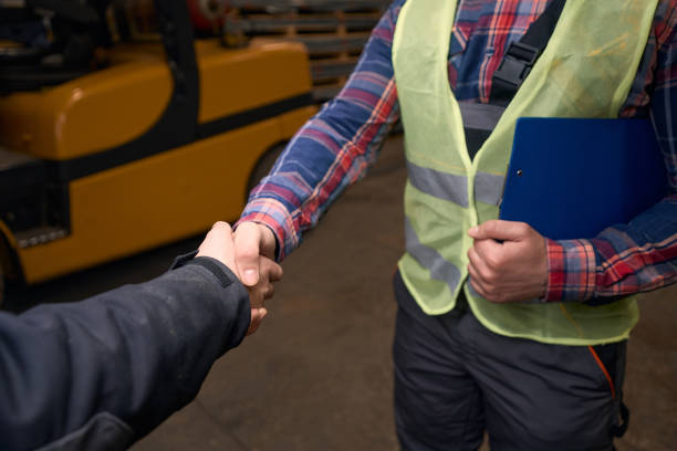 istock Builder shaking hands with man after successful deal in warehouse 1457496141