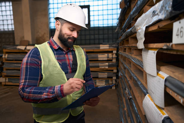 istock Portrait of foreman making notes in warehouse 1457496174