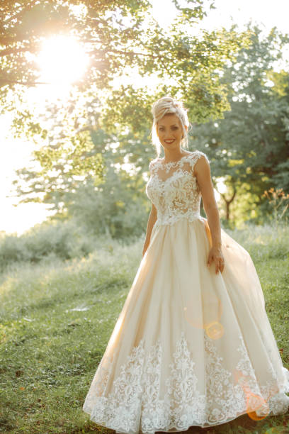 istock Beautiful young bride enjoying sunny day in nature 1457496530