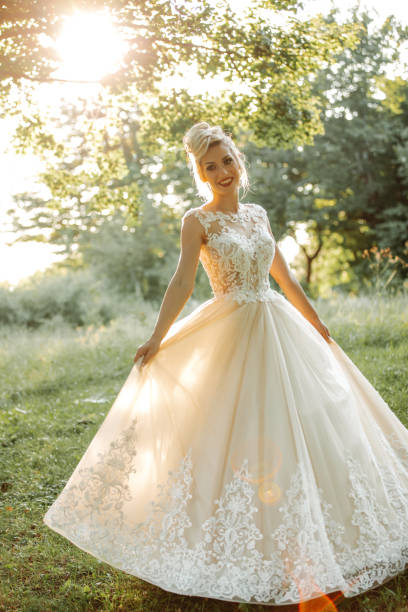 Beautiful young bride enjoying sunny day in nature