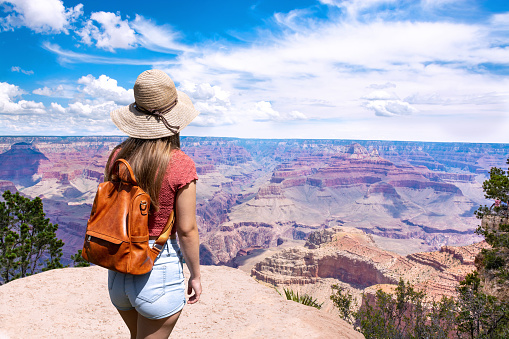 Woman hiker looking at beautiful mountain view. South Rim, Grand Canyon National Park, Arizona, USA.