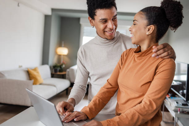 istock Boyfriend and girlfriend using a laptop at home 1457497405