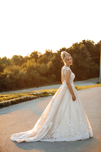 Beautiful bride walking on country road