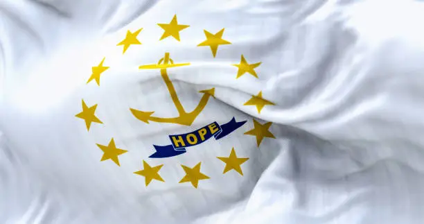 Close-up of the Rhode Island state flag waving. Gold anchor in the center surrounded by thirteen gold stars. Rippled fabric. Textured background. Selective focus. Realistic 3d illustration