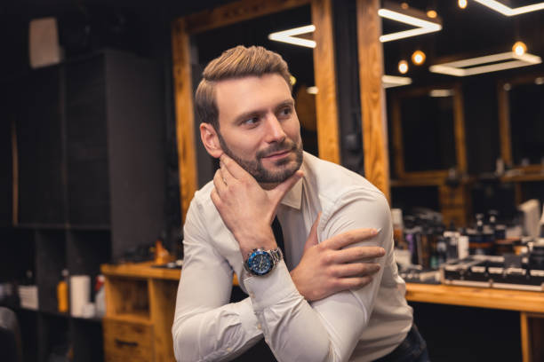 istock Fair-haired stylish young man in a barbershop 1457501918