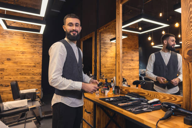 istock Barber with hairdressing tools an the barbershop 1457502340