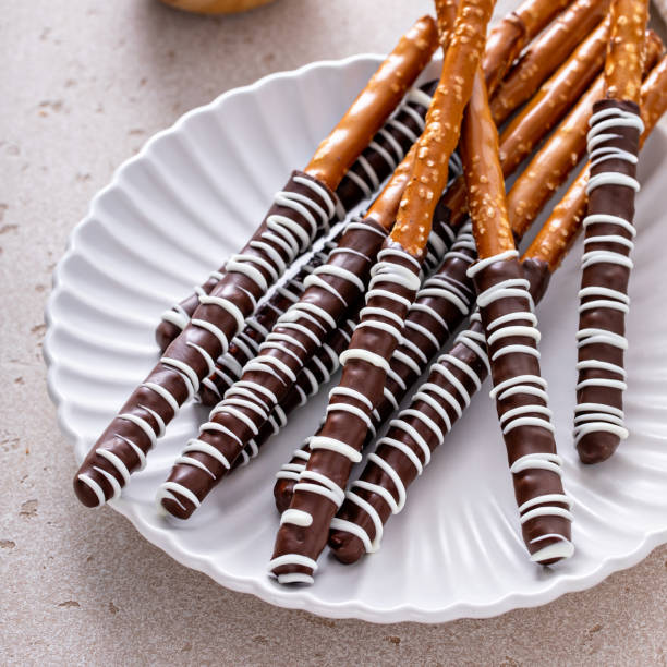 istock Chocolate covered pretzel rods homemade on a white plate 1457502383