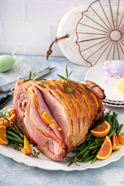 istock Easter ham stuffed with orange slices, spiral sliced glazed ham 1457502487