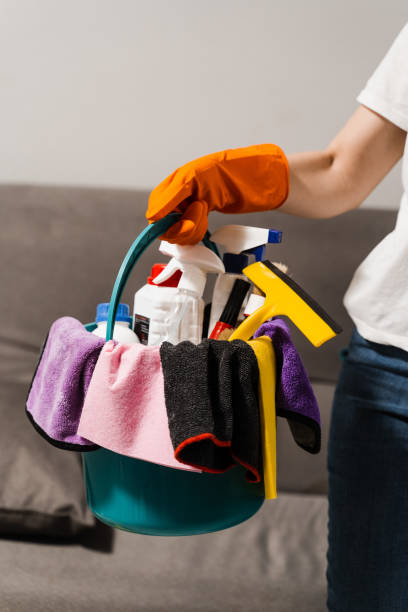 istock Girl cleaner in gloves is holding bucket with detergent and microfiber rags for house cleaning. Professional domestic cleaning service. 1457504142