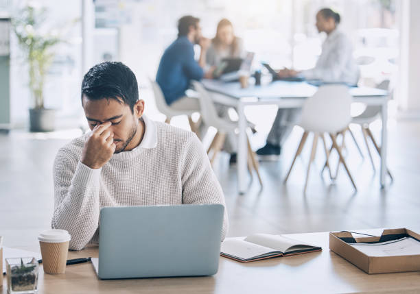 istock Stress, laptop and burnout with a business man at work on his laptop while suffering from a headache. Compliance, computer and anxiety with a male employee working while struggling with fatigue 1457505162