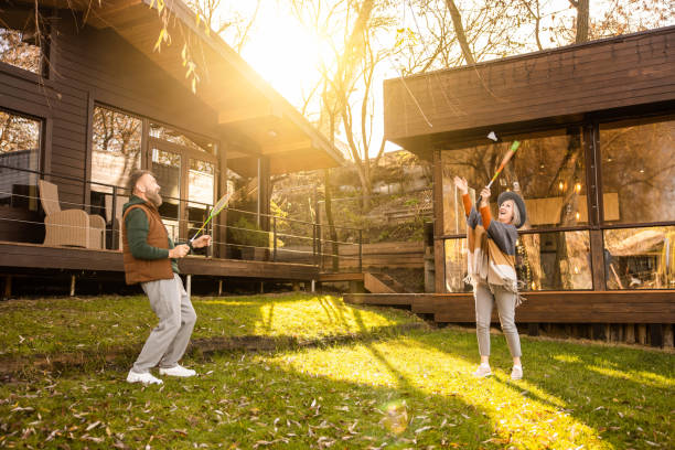 istock Mature couple playing badminton and looking involved 1457507454