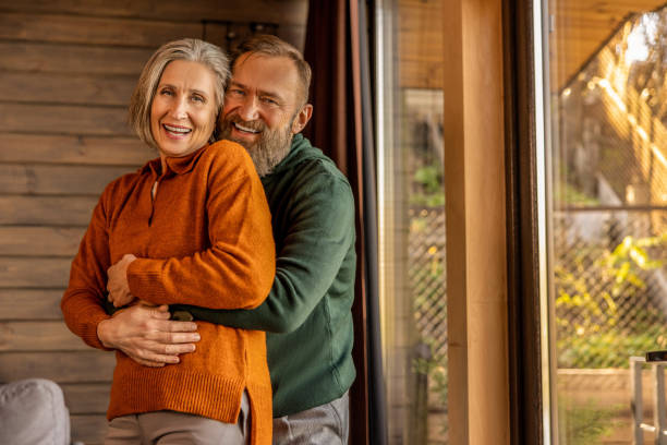 istock Man hugging his wife and both looking happy and contented 1457507549