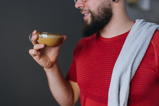 Man drinking coffee before workout