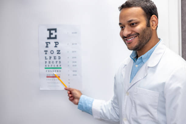 istock Smiling male doctor standing near eyesight check list 1457510945