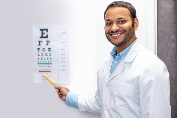 istock Smiling male doctor standing near eyesight check list 1457510963