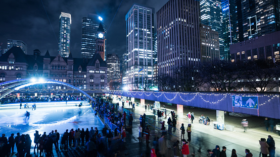 Toronto, Ontario, Canada- January 1sh, 2023:Ice skating in Nathan Phillips Square at night