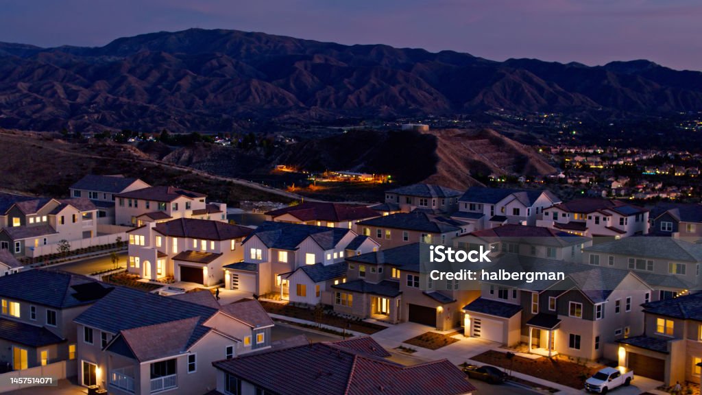Aerial View of Illuminated Homes in Santa Clarita Aerial shot of Santa Clarita, California on a beautiful autumn evening. Santa Clarita is a suburb in Los Angeles County north of the city of Los Angeles. Residential District Stock Photo
