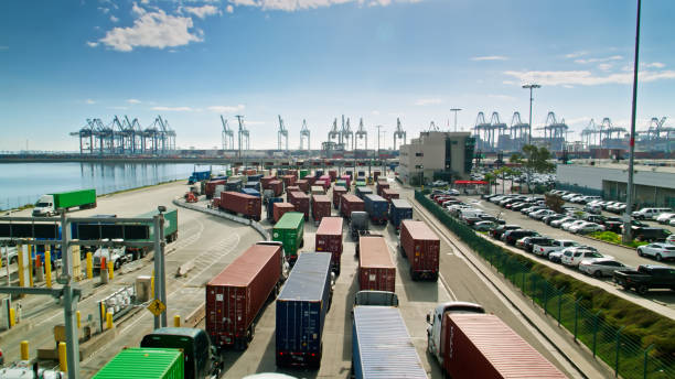 scatto del drone dei camion all'ingresso del terminal nel porto di los angeles - trasporto merci via terra foto e immagini stock