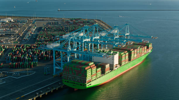 Aerial Shot of Container Ship Being Unloaded with Pacific Ocean Beyond