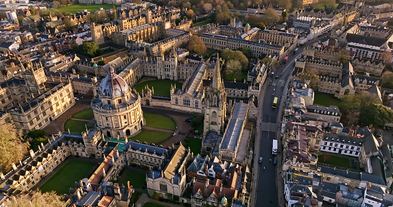 Rooftop view on historical university buildings towards All Souls College, Oxford, United Kingdom. Overcast sky.