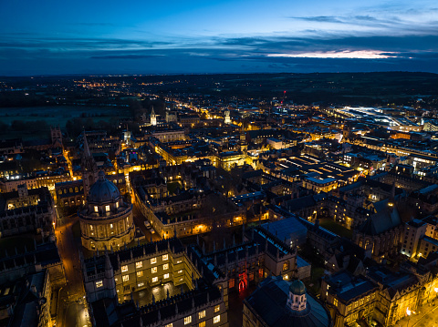 Aerial view of of Oxford, England on a cloudy evening in winter, flying over the city centre buildings and the colleges and libraries of the famous university. This still image is part of a series; a time lapse video is also available.