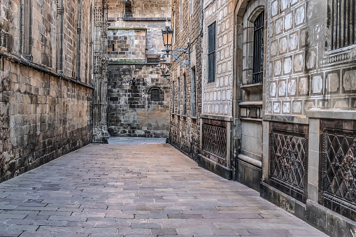 Empty deserted Carrer de la Pietat street in the Gothic Quarter of Barcelona, Spain