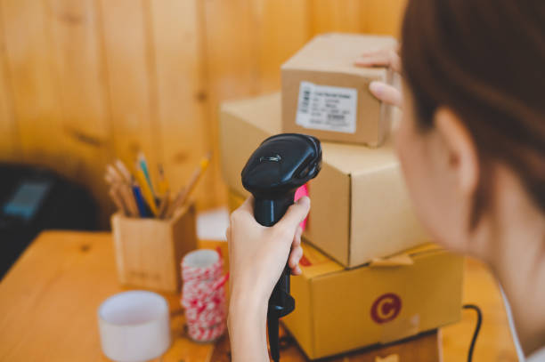 istock Small business owners online are scanning barcode-labelled parcel boxes with a barcode scanner to verify their product orders. of online retailers - online shopping 1457528915