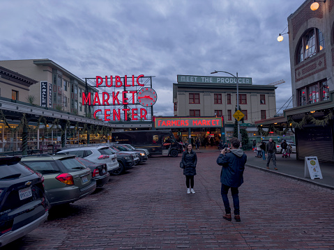 Street view of Pike Place Market in downtown, Seattle, WA, USA on a rainy winter day.