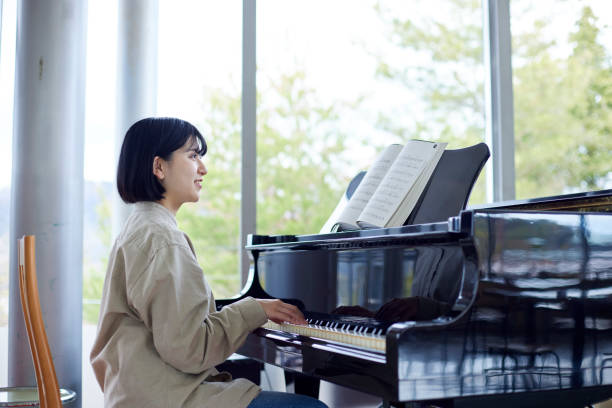istock Young Japanese women playing the piano 1457538574