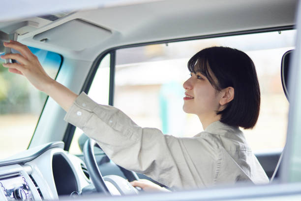 young japanese woman driving  a car - driving car drive women imagens e fotografias de stock
