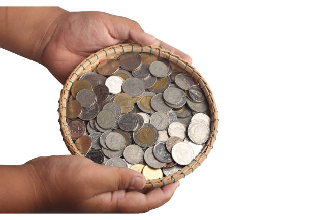 istock Coins in a bamboo basket on a white background.Saving money concept 1457538861