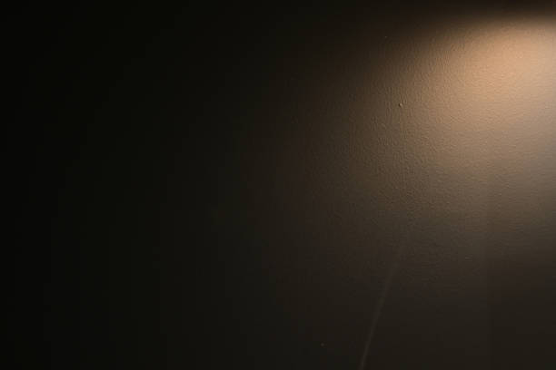 istock brown wall background with lights and black shadow 1457546008