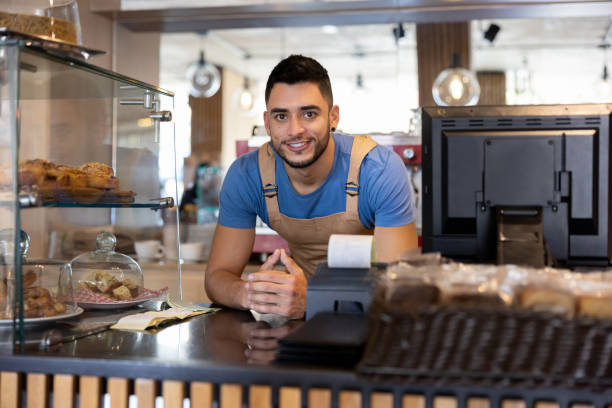 istock Happy barista working at a cafe 1457547114