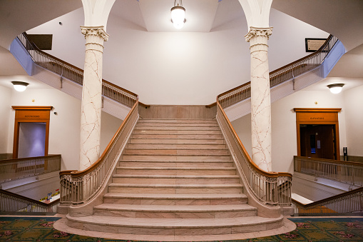 Converging lines and angles of an old staircase inside the Portland Central Library.