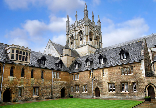 Oxford, England - July 8 2009:  A medieval building of Merton College, Oxford University, with the gothic tower of the chapel in the background