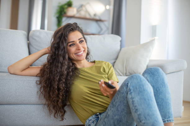 istock Woman watching TV in the room 1457550864