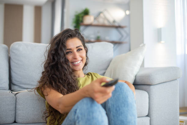 istock Woman watching TV in the room 1457550877