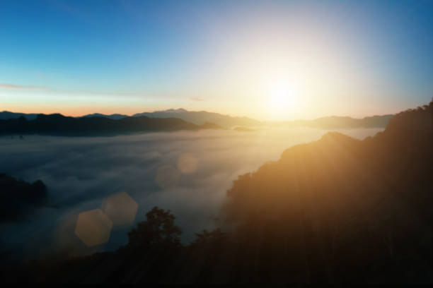 istock Natural background blurring warm colors and bright sun light. Bokeh or Christmas background Green Energy at sky sunny color orange light patterns plain abstract flare evening clouds blur. 1457551197