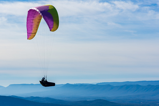 Dickey Ridge, Virginia - January 16, 2023 - A paraglider sails in Shenandoah National Park on a sunny winter afternoon.