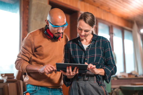 istock Front Portrait of Carpenters Working and Using Digital Tablet 1457553440
