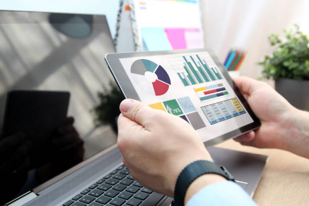 istock Business man working and analyzing financial figures on a laptop 1457568186