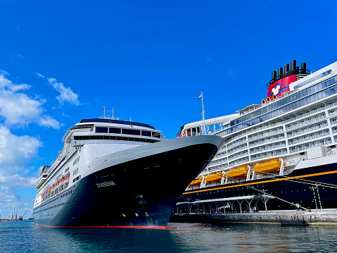 Nassau, The Bahamas - January 3, 2023: Holland America’s “Zaandam” cruise ship and the Disney “Wish” cruise ship are moored next to each other at the Port of Nassau during scheduled visits to the Bahamian capital.
