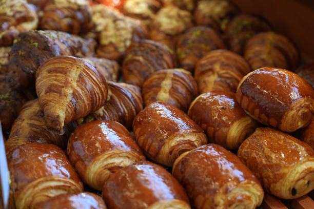 istock Freshly baked pastry and croissants on a display in bakery 1457580794