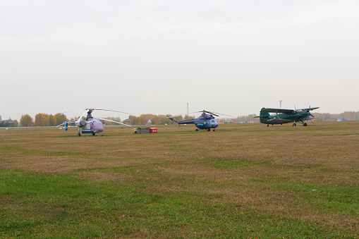 Novosibirsk, Siberia, Russia - September 25, 2022.\nAn airfield with helicopters and an airplane in the parking lot.